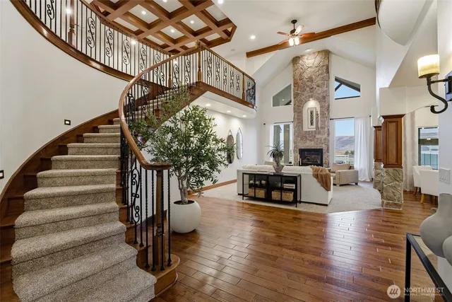 a living room with fireplace furniture and a wooden floor