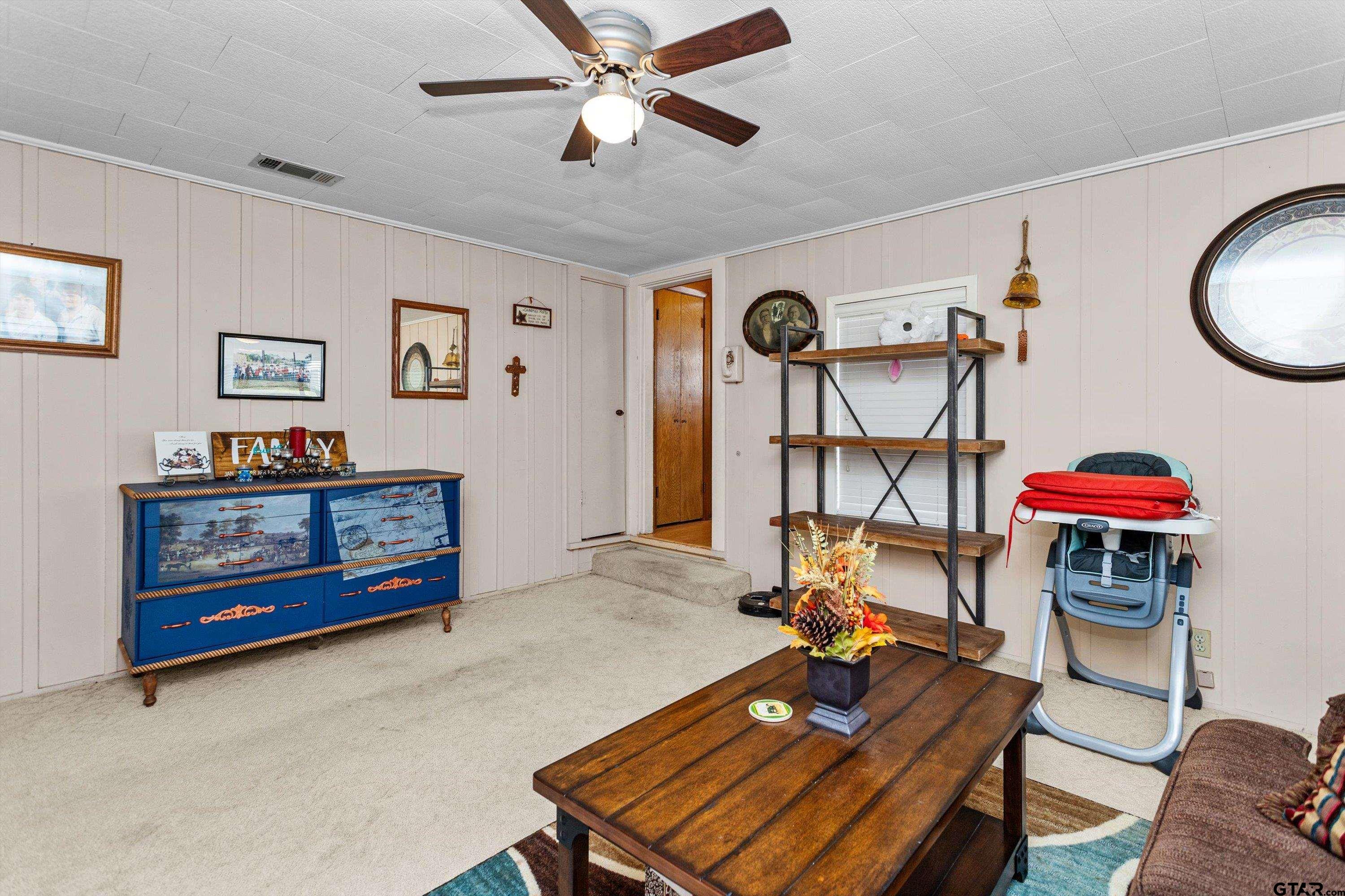 552 Highway 7 Crockett, TX 75835 - Photo 11 of 35 a living room with furniture gym equipment and a chandelier