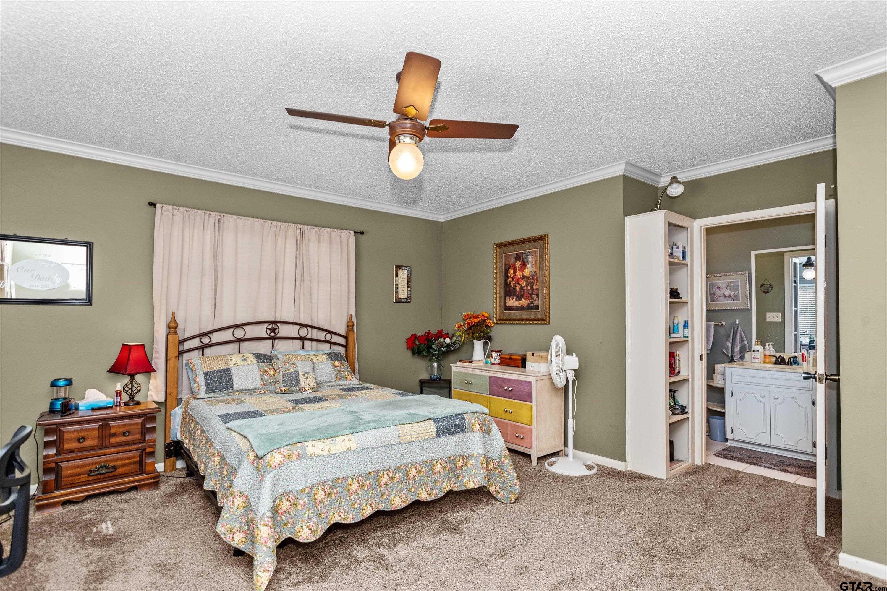 552 Highway 7 Crockett, TX 75835 - Photo 13 of 35 a bedroom with a bed and a chandelier