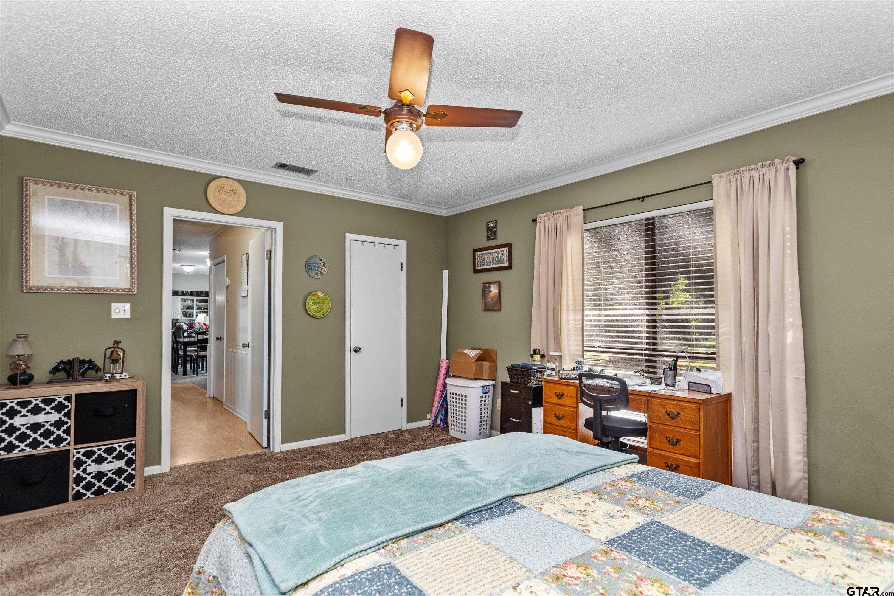 552 Highway 7 Crockett, TX 75835 - Photo 14 of 35 a bedroom with a bed a chandelier and dresser