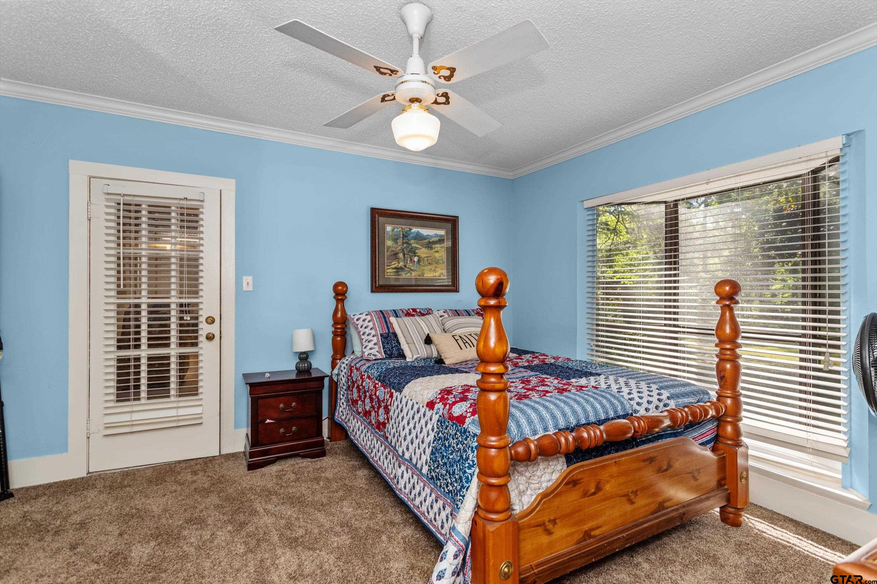 552 Highway 7 Crockett, TX 75835 - Photo 20 of 35 a bed sitting in a bedroom next to a window
