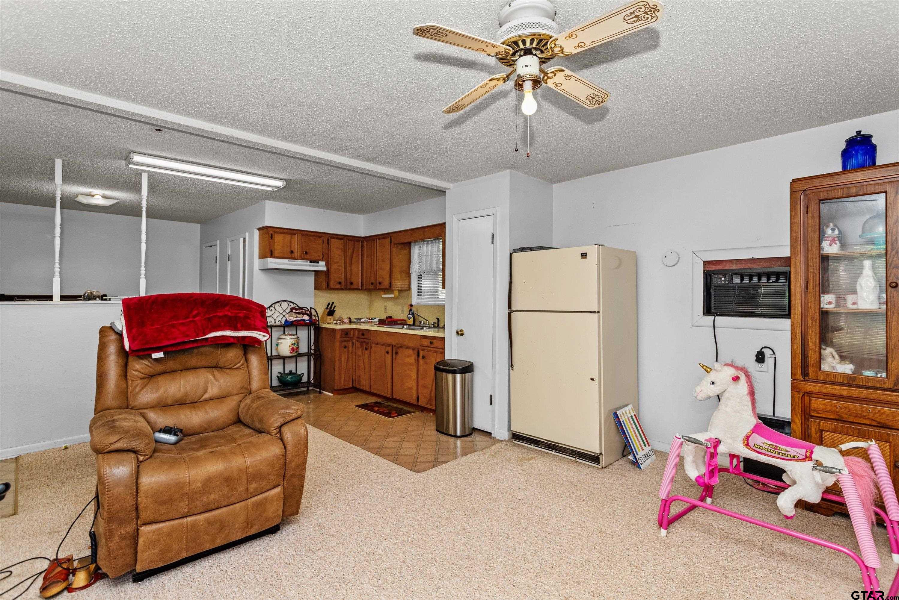 552 Highway 7 Crockett, TX 75835 - Photo 23 of 35 a living room with furniture and a refrigerator