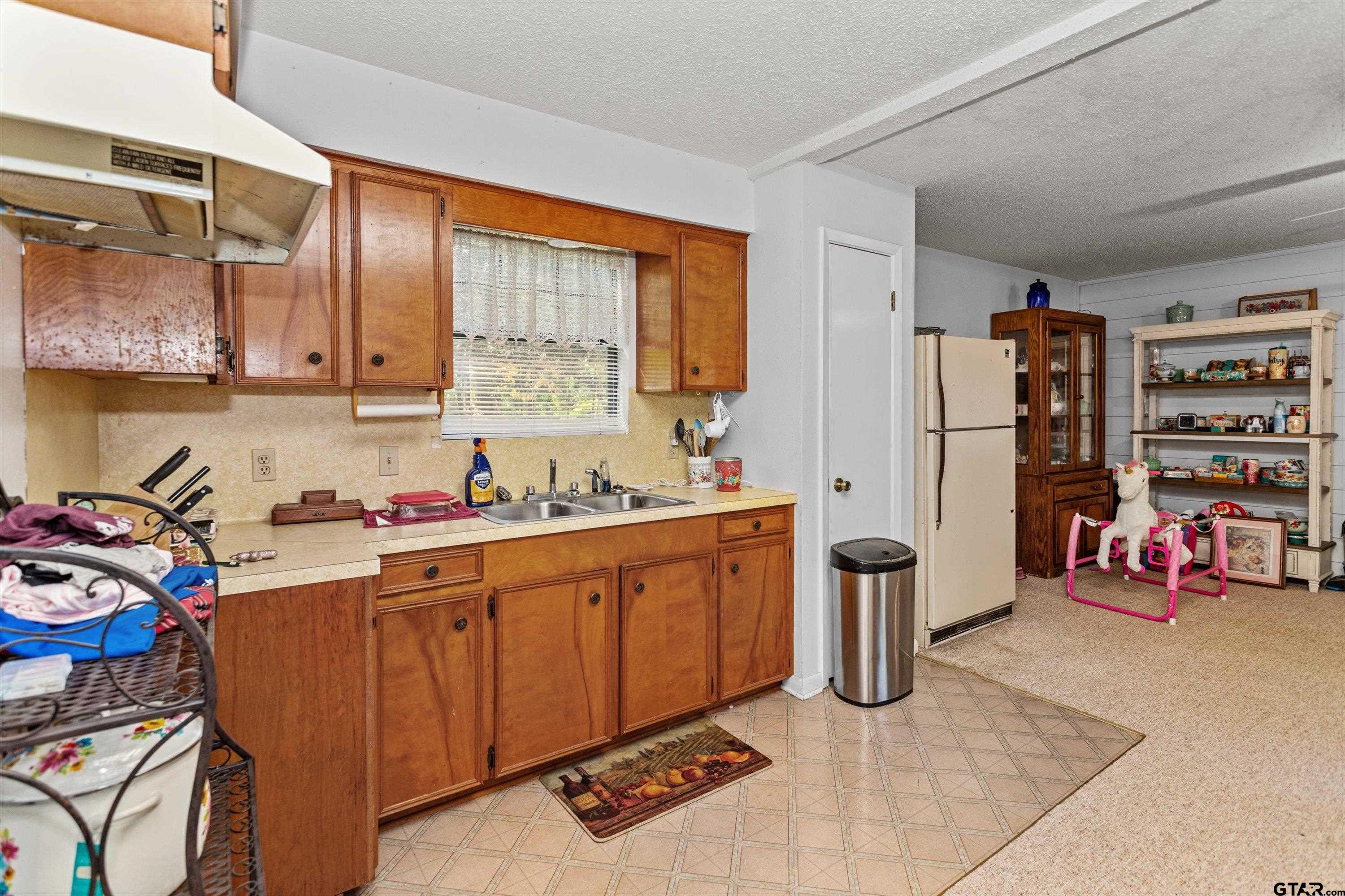 552 Highway 7 Crockett, TX 75835 - Photo 24 of 35 a kitchen with refrigerator and sink