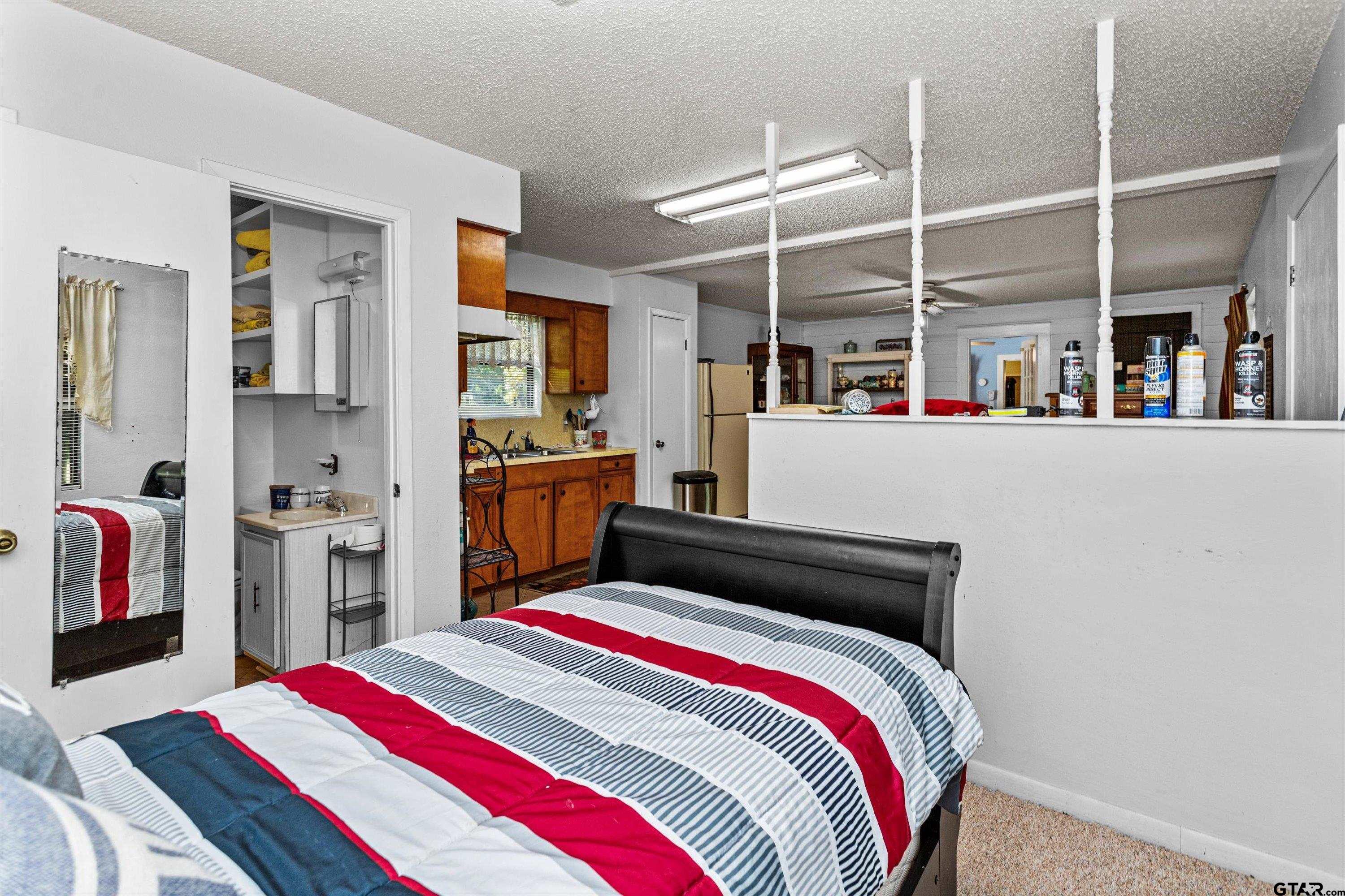 552 Highway 7 Crockett, TX 75835 - Photo 26 of 35 a bedroom with a bed and a book shelf