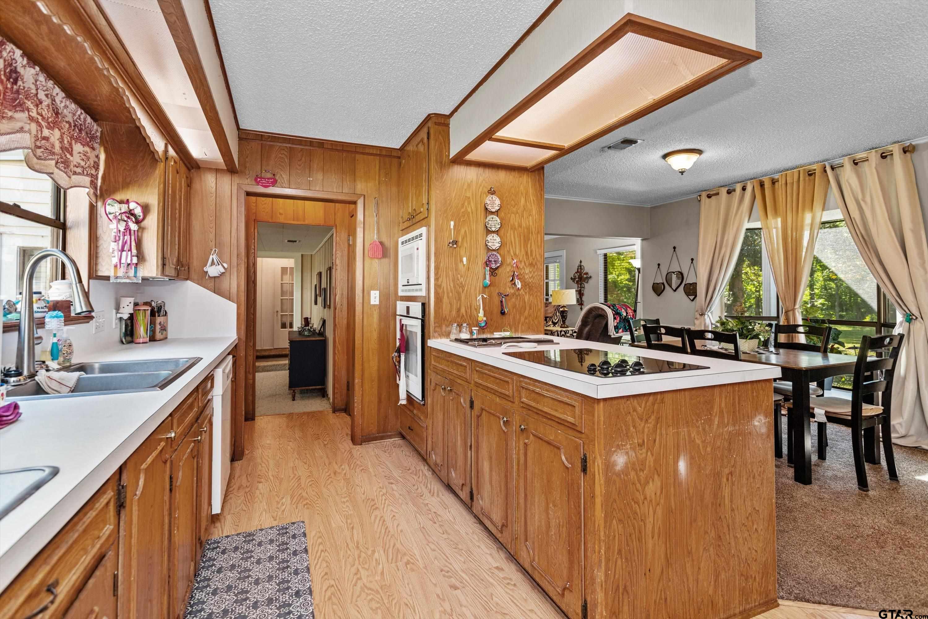 552 Highway 7 Crockett, TX 75835 - Photo 8 of 35 a kitchen with kitchen island a stove a sink and a refrigerator