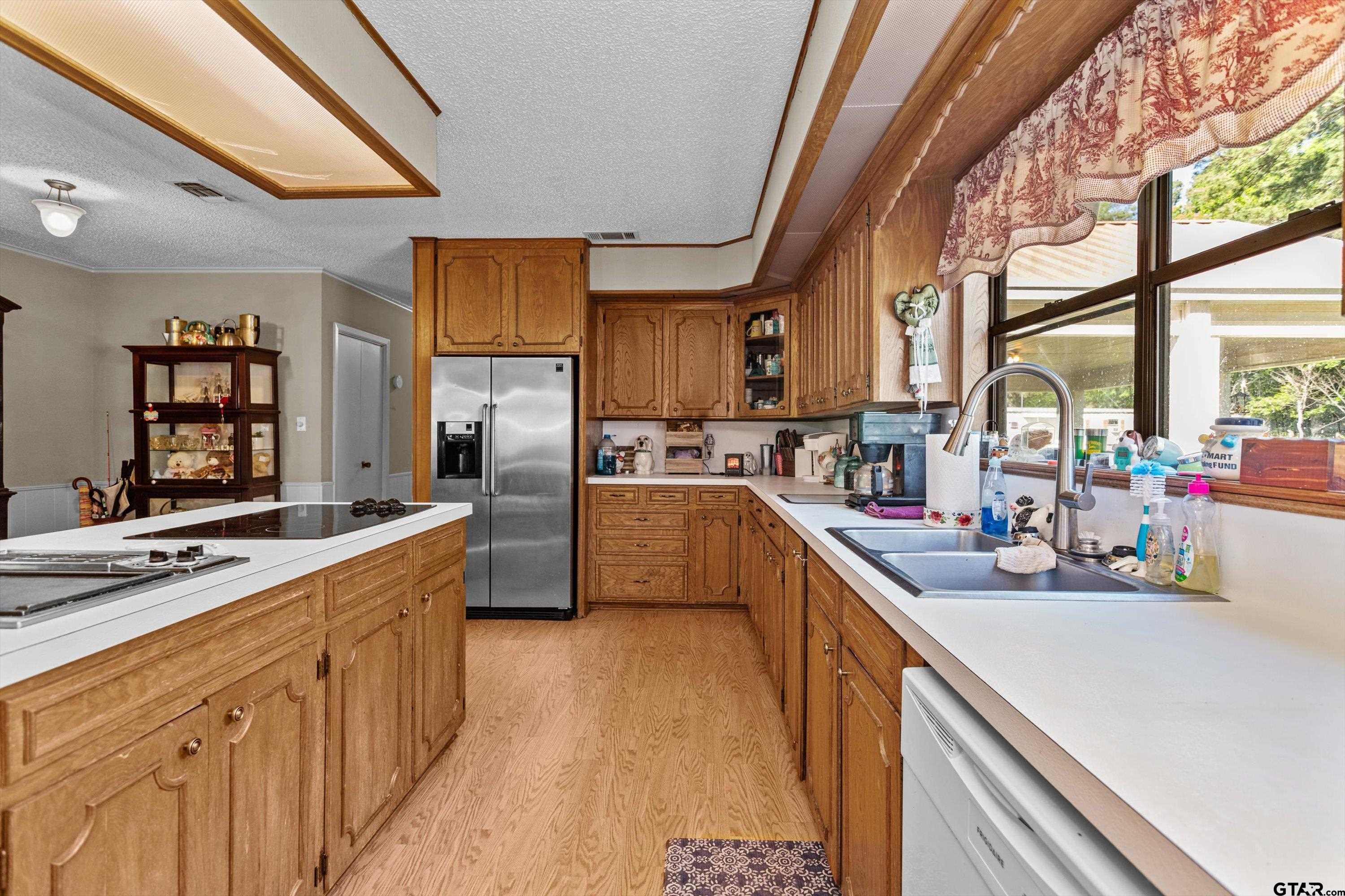 552 Highway 7 Crockett, TX 75835 - Photo 9 of 35 a kitchen with stainless steel appliances sink a microwave and cabinets