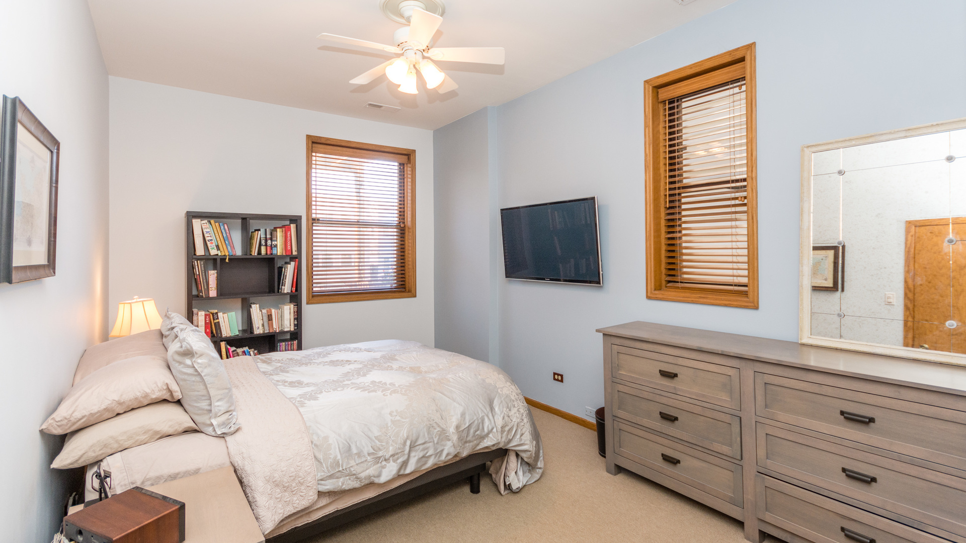 3810 North Fremont Street, Unit 2B Chicago, IL 60613 - Photo 12 of 22 a bedroom with a bed and a flat screen tv