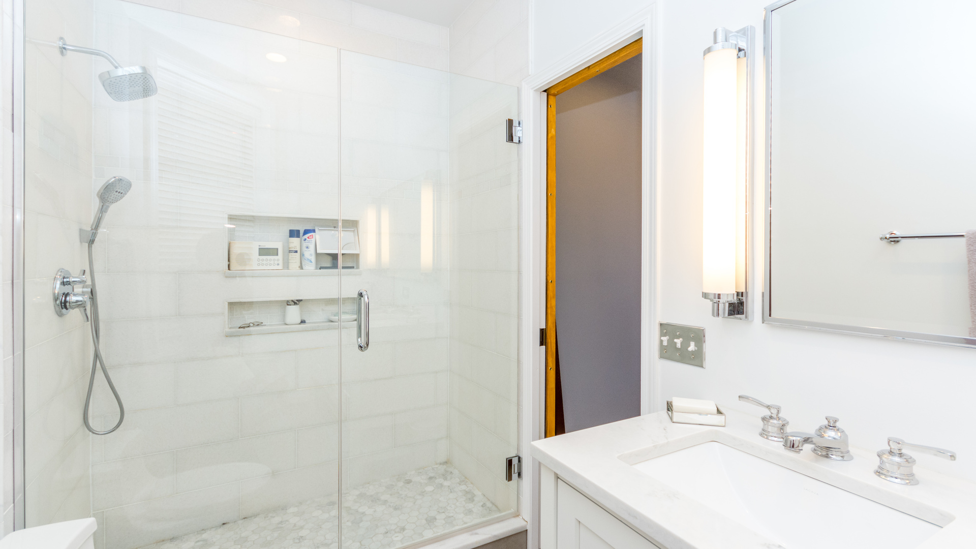 3810 North Fremont Street, Unit 2B Chicago, IL 60613 - Photo 14 of 22 a bathroom with a granite countertop shower sink vanity and mirror