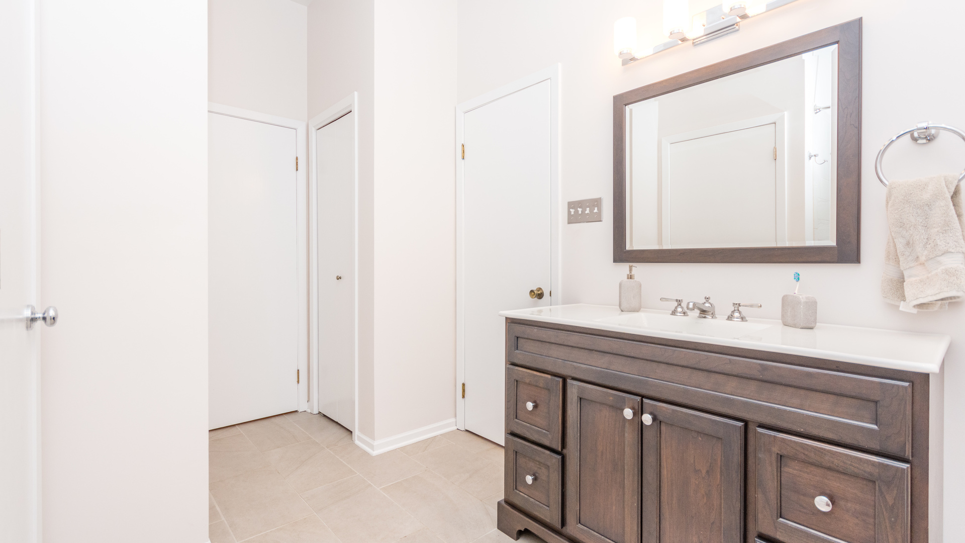 3810 North Fremont Street, Unit 2B Chicago, IL 60613 - Photo 17 of 22 a bathroom with a sink a vanity and a mirror