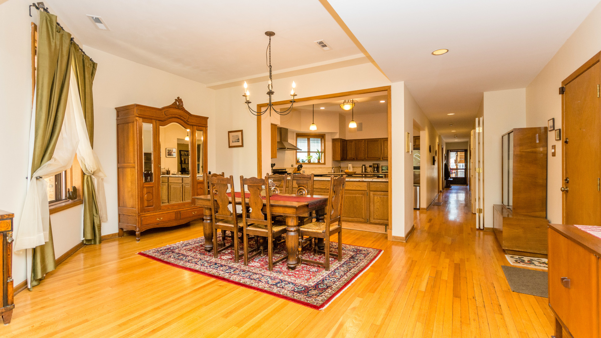 3810 North Fremont Street, Unit 2B Chicago, IL 60613 - Photo 5 of 22 a dining room with stainless steel appliances granite countertop a table chairs and a rug