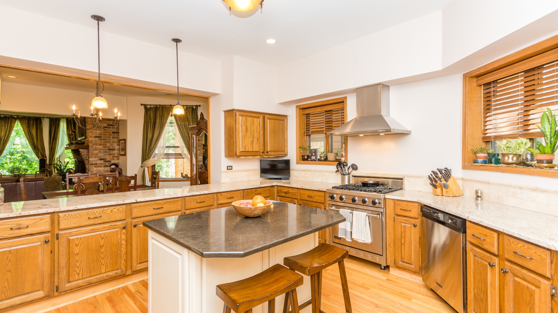 3810 North Fremont Street, Unit 2B Chicago, IL 60613 - Photo 8 of 22 a kitchen with stainless steel appliances granite countertop a sink a stove and a wooden floors