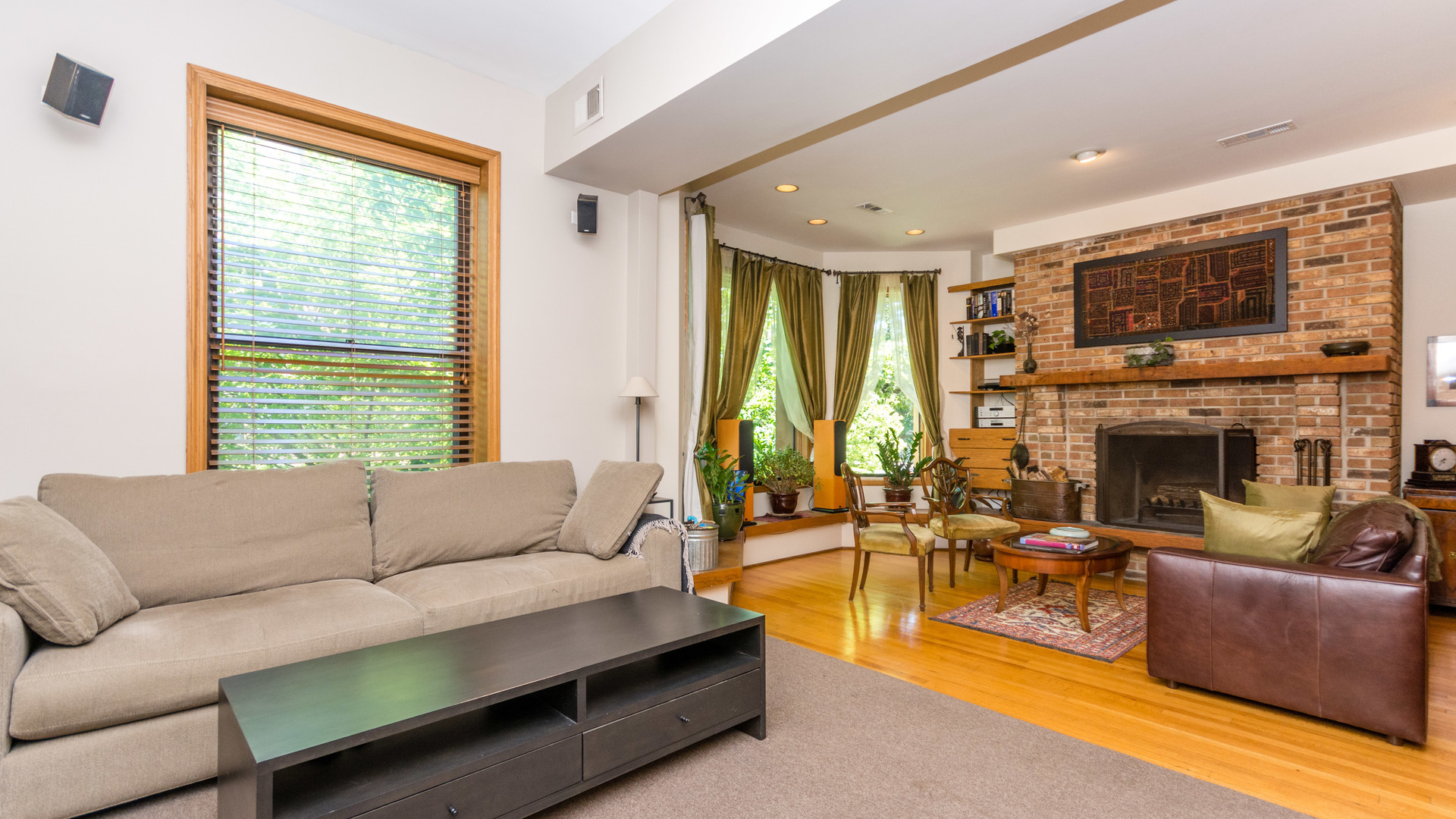 3810 North Fremont Street, Unit 2B Chicago, IL 60613 - Photo 10 of 22 a living room with furniture a large window and a fireplace