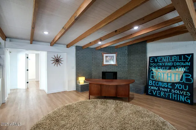 a view of a hallway with wooden floor and windows