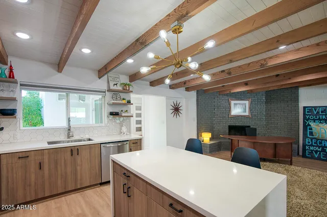a large white kitchen with a large island