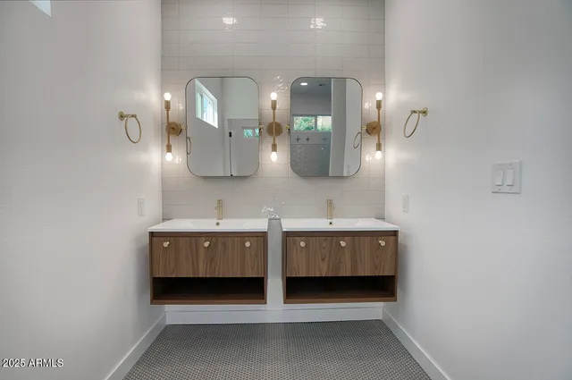 a bathroom with a double vanity sink and a mirror