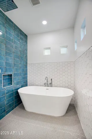 a spacious bathroom with a bathtub and shower