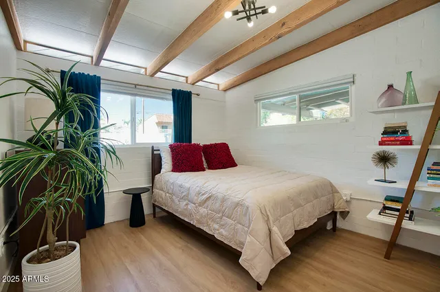 a bedroom with a bed and a potted plant