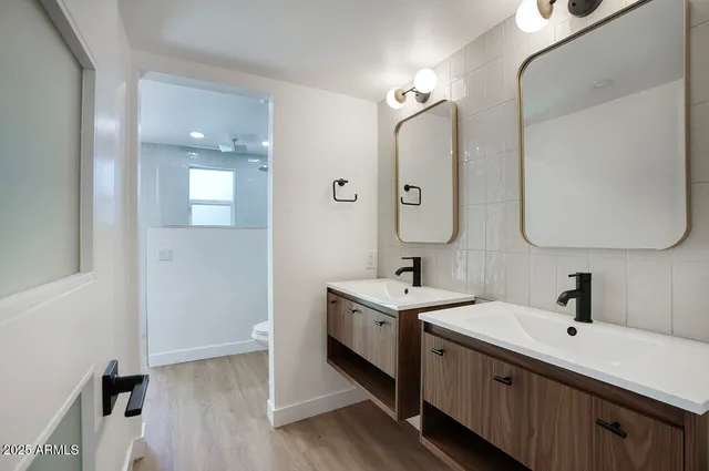 a spacious bathroom with a double vanity sink double and mirror