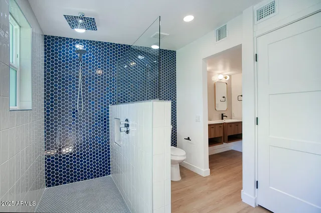 a bathroom with a shower and a sink