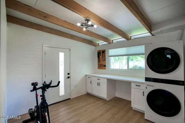a view of a hallway with washer and dryer