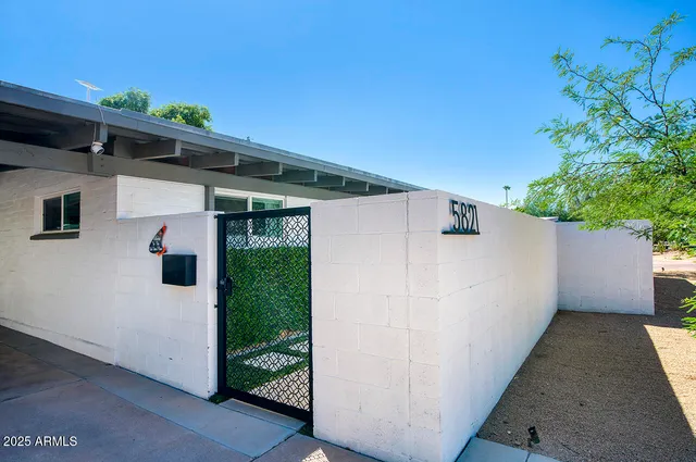 a view of a house with a backyard