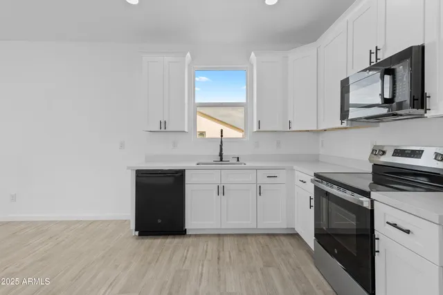 a kitchen with stainless steel appliances a sink stove and refrigerator