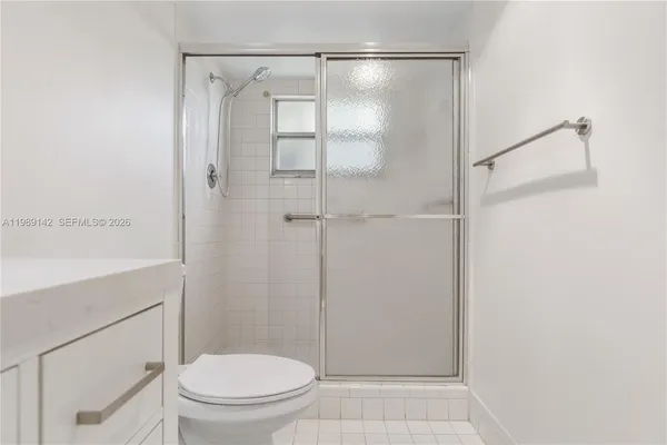 a bathroom with a shower a toilet and a sink