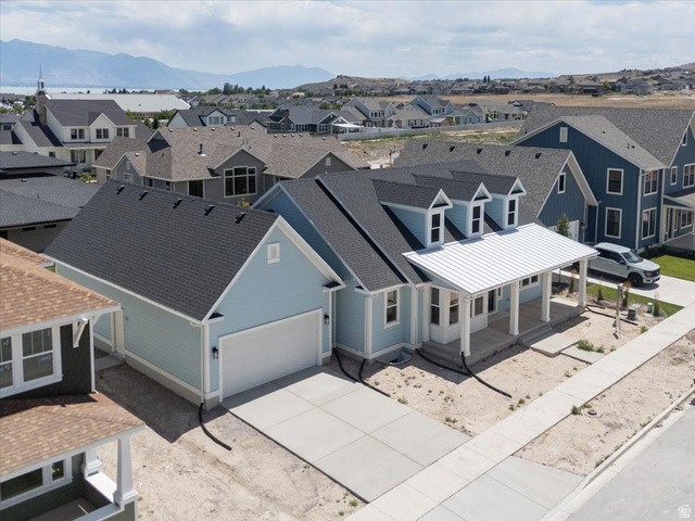952 Mathilda Drive, Unit 156 Saratoga Springs, UT 84045 - Photo 3 of 25 Light blue siding exterior featuring a covered porch with white columns, a metal roof accent, and three dormer windows
