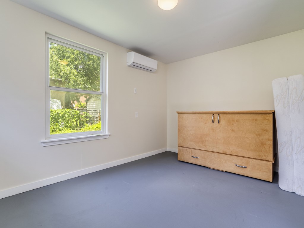 2314 Santa Rosa Street Austin, TX 78702 - Photo 17 of 27 Unfurnished bedroom with finished concrete floors and a wall mounted mini split