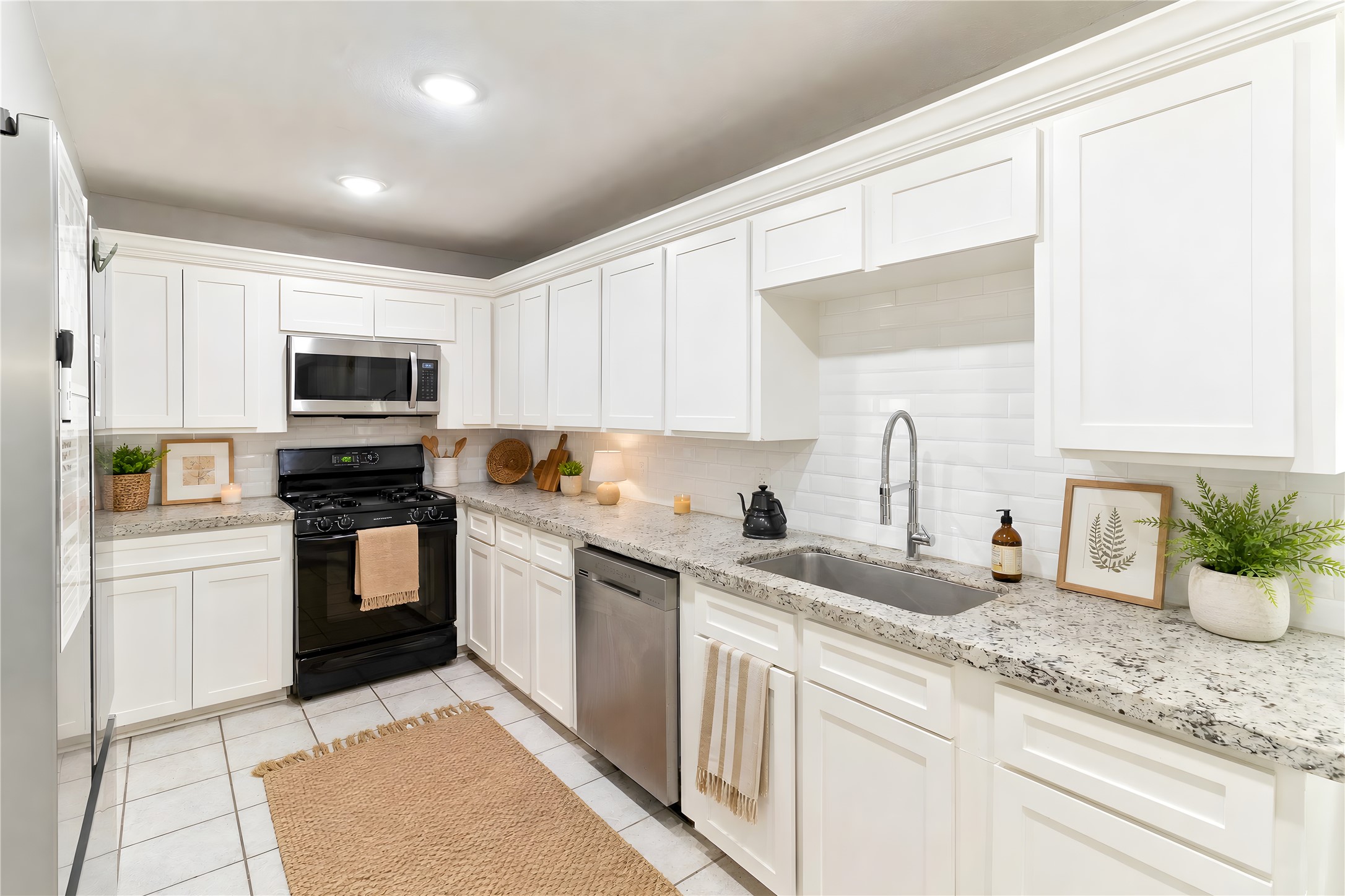 117 Cannon Street Clute, TX 77531 - Photo 2 of 24 A deep single-basin sink, and gas stove add function to the kitchen.