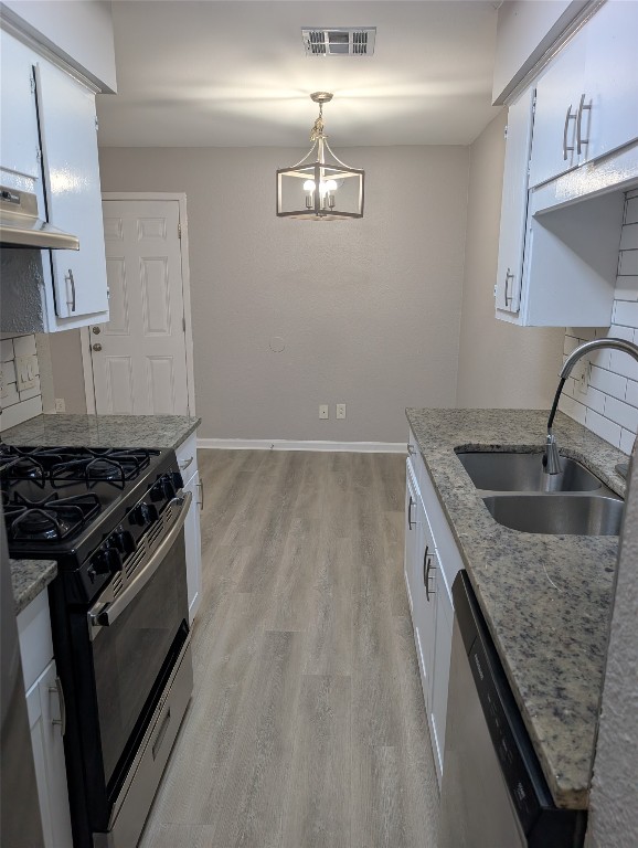 5102 Par Cove, Unit B Austin, TX 78744 - Photo 2 of 11 a kitchen with granite countertop a sink stove and refrigerator