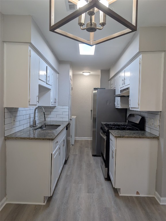 5102 Par Cove, Unit B Austin, TX 78744 - Photo 3 of 11 a kitchen with stainless steel appliances granite countertop a sink and stove