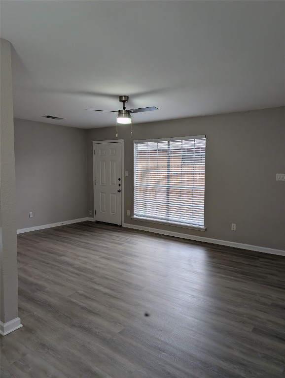 5102 Par Cove, Unit B Austin, TX 78744 - Photo 4 of 11 an empty room with wooden floor chandelier and windows