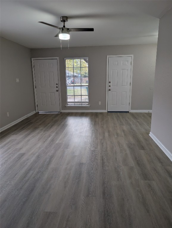 5102 Par Cove, Unit B Austin, TX 78744 - Photo 5 of 11 an empty room with wooden floor ceiling fan and windows