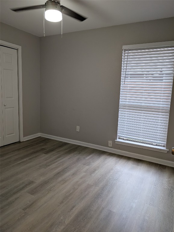 5102 Par Cove, Unit B Austin, TX 78744 - Photo 9 of 11 a view of an empty room with wooden floor and a window