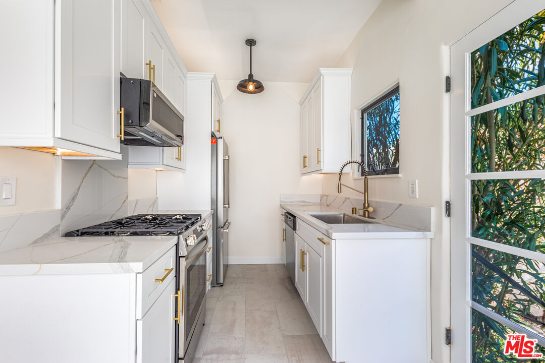 152 South Roxbury Drive, Unit 6 Beverly Hills, CA 90212 - Photo 11 of 51 a kitchen with stainless steel appliances granite countertop a stove and a sink