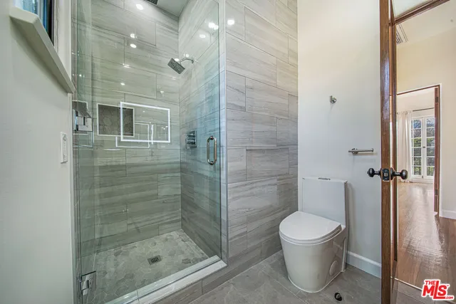 a bathroom with a toilet and a shower
