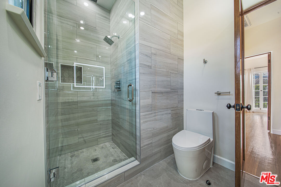 152 South Roxbury Drive, Unit 6 Beverly Hills, CA 90212 - Photo 18 of 51 a bathroom with a toilet and a shower
