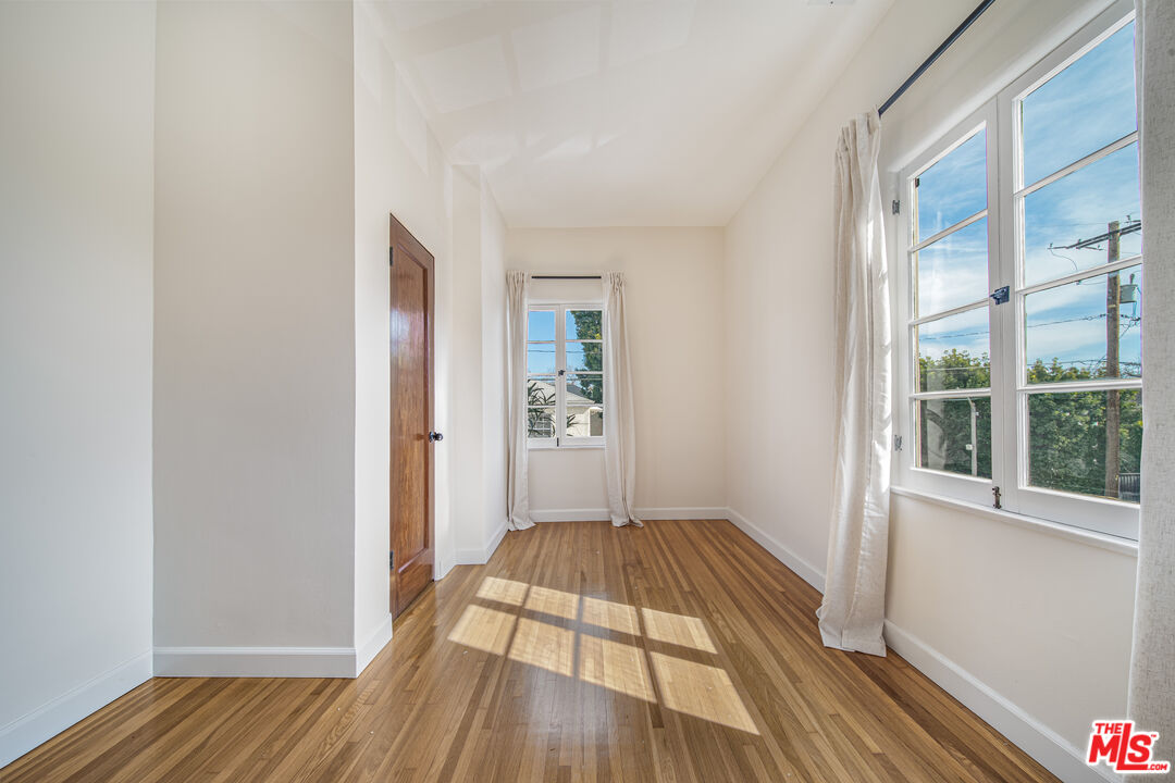 152 South Roxbury Drive, Unit 6 Beverly Hills, CA 90212 - Photo 24 of 51 wooden floor in a empty room with a window