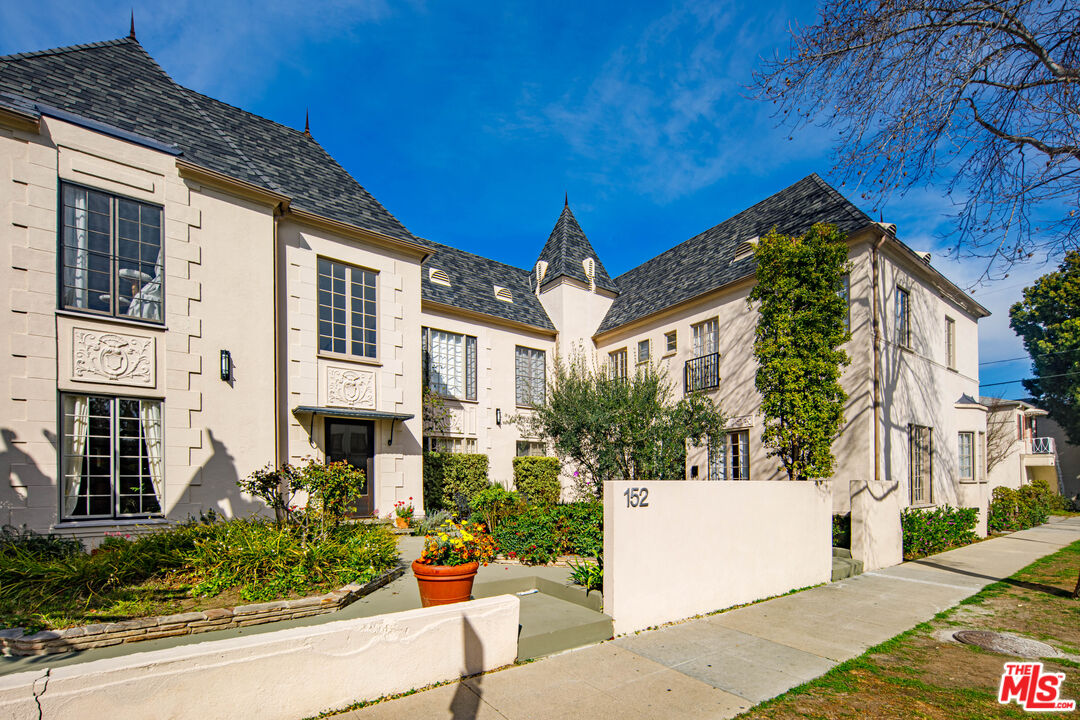 152 South Roxbury Drive, Unit 6 Beverly Hills, CA 90212 - Photo 38 of 51 a view of a white house with a large windows