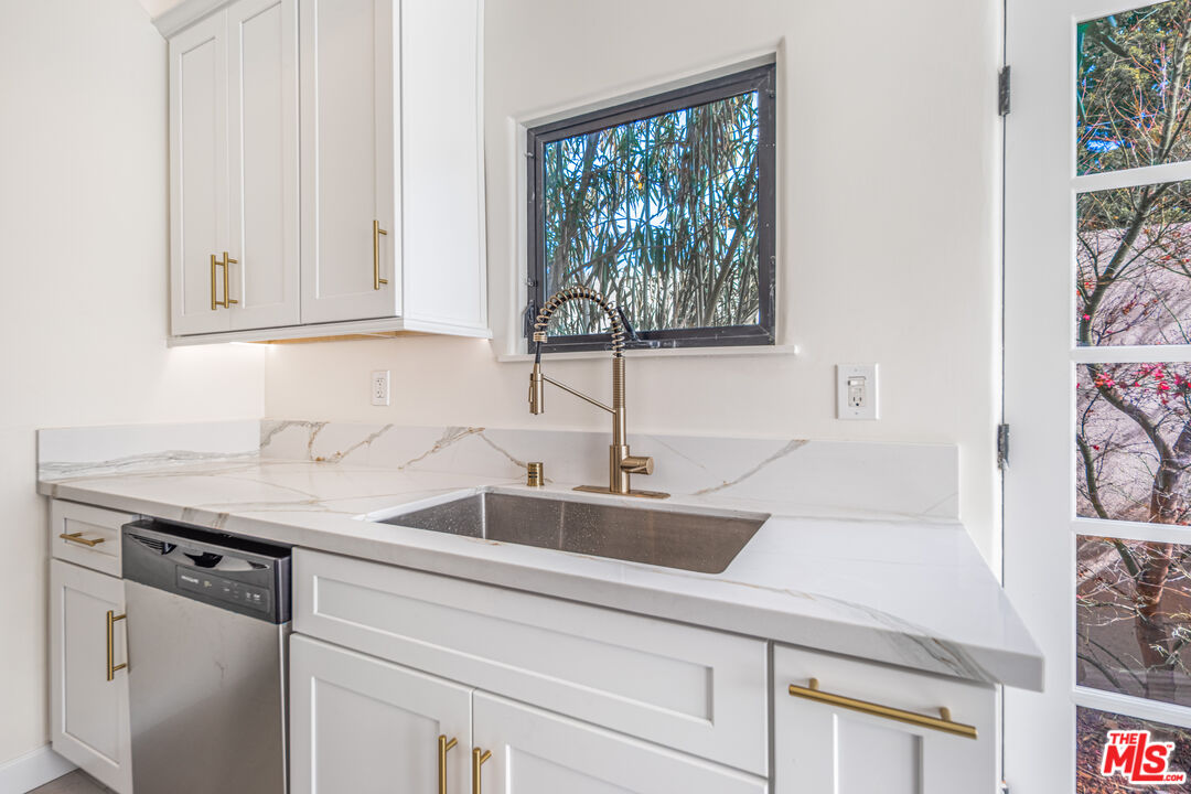152 South Roxbury Drive, Unit 6 Beverly Hills, CA 90212 - Photo 9 of 51 a kitchen with a sink and cabinets