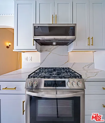 a stove top oven sitting inside of a kitchen
