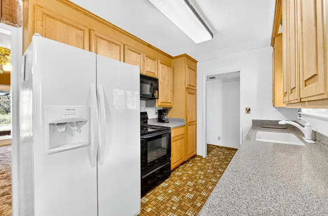 a living room with furniture a fireplace and a large window
