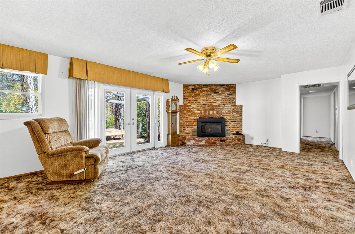 1130 Sage Road Colfax, CA 95713 - Photo 15 of 77 a living room with furniture a fireplace and a large window