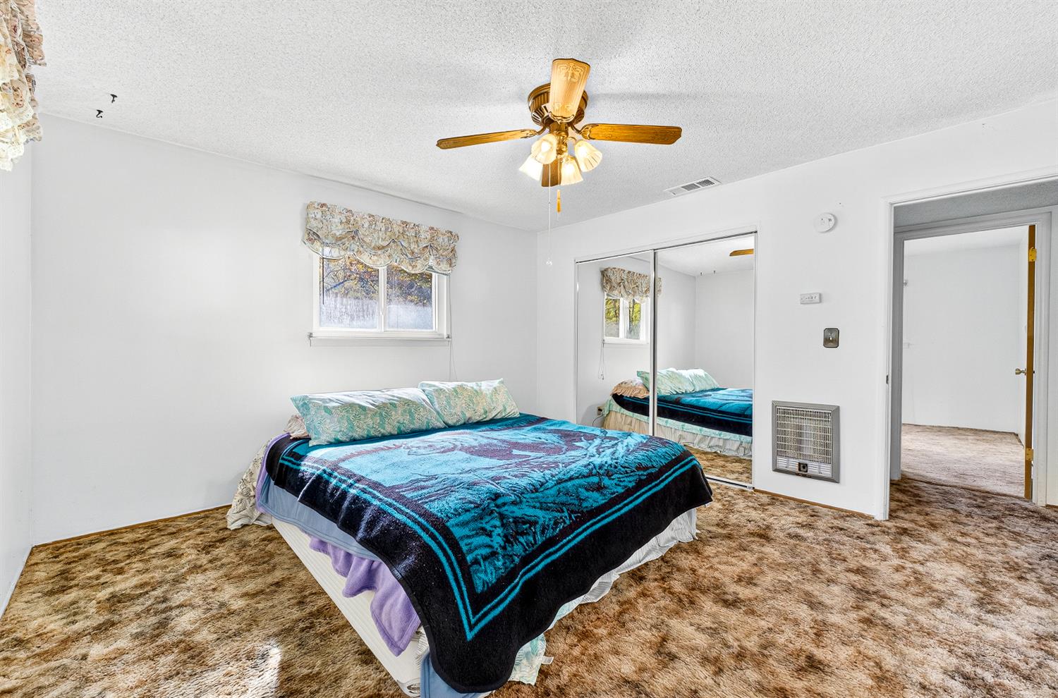 1130 Sage Road Colfax, CA 95713 - Photo 25 of 77 a bedroom with a bed and a chandelier