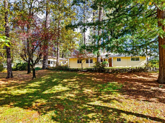 a view of a house with pool and chairs
