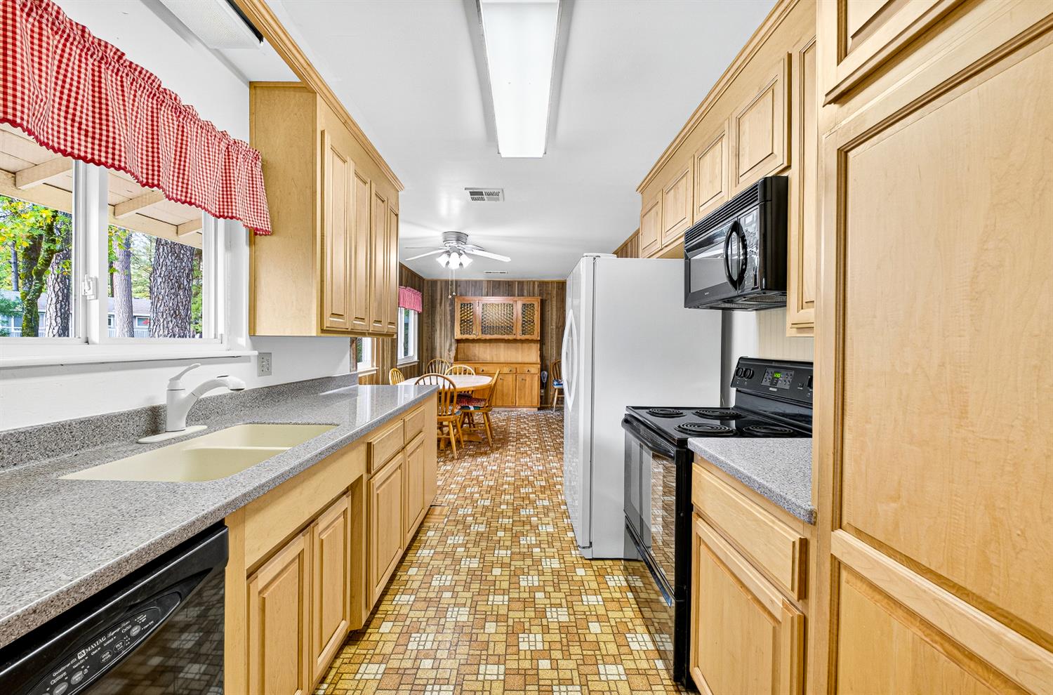 1130 Sage Road Colfax, CA 95713 - Photo 5 of 77 a kitchen with stainless steel appliances granite countertop a sink a stove and a refrigerator