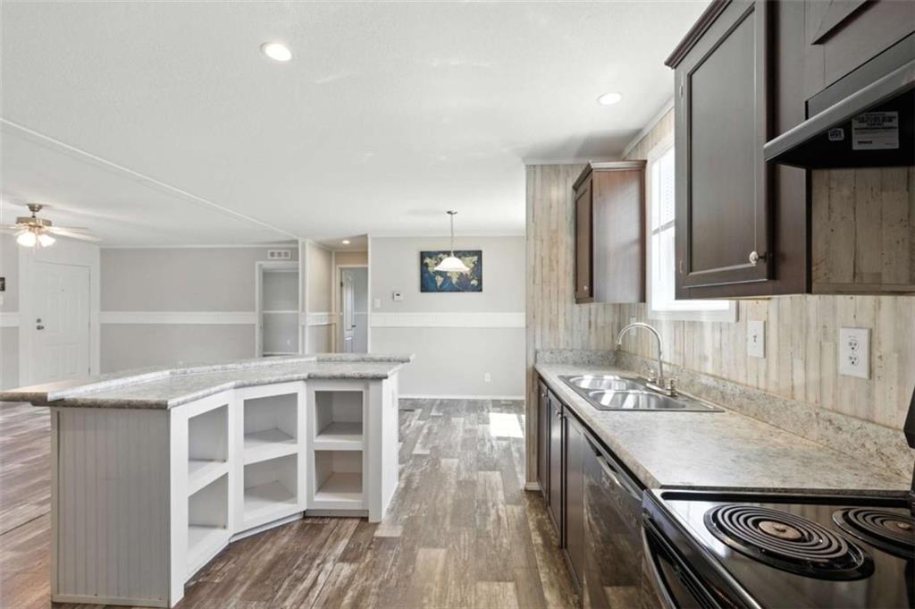 120 Beck Road Mount Airy, GA 30563 - Photo 14 of 30 a kitchen with stainless steel appliances granite countertop a sink stove and cabinets