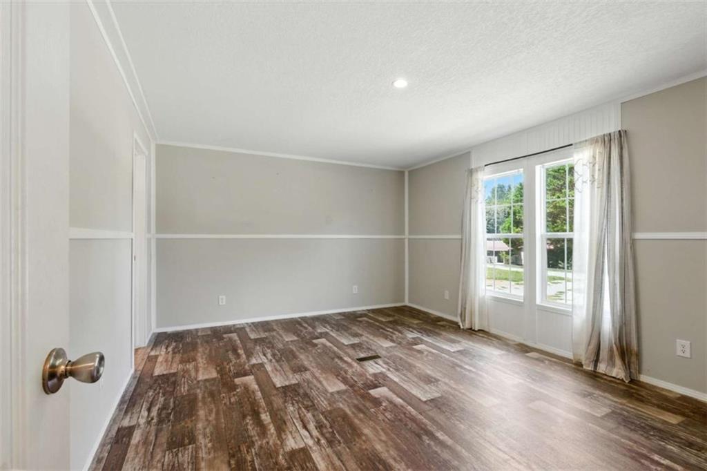 120 Beck Road Mount Airy, GA 30563 - Photo 22 of 30 an empty room with wooden floor and windows