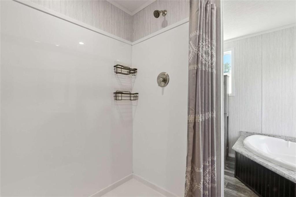 120 Beck Road Mount Airy, GA 30563 - Photo 27 of 30 a bathroom with a bathtub and shower
